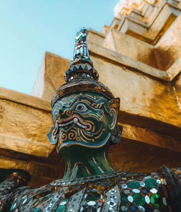 Colorful cartoon style illustration of Thailand with beach, palm trees and golden temple