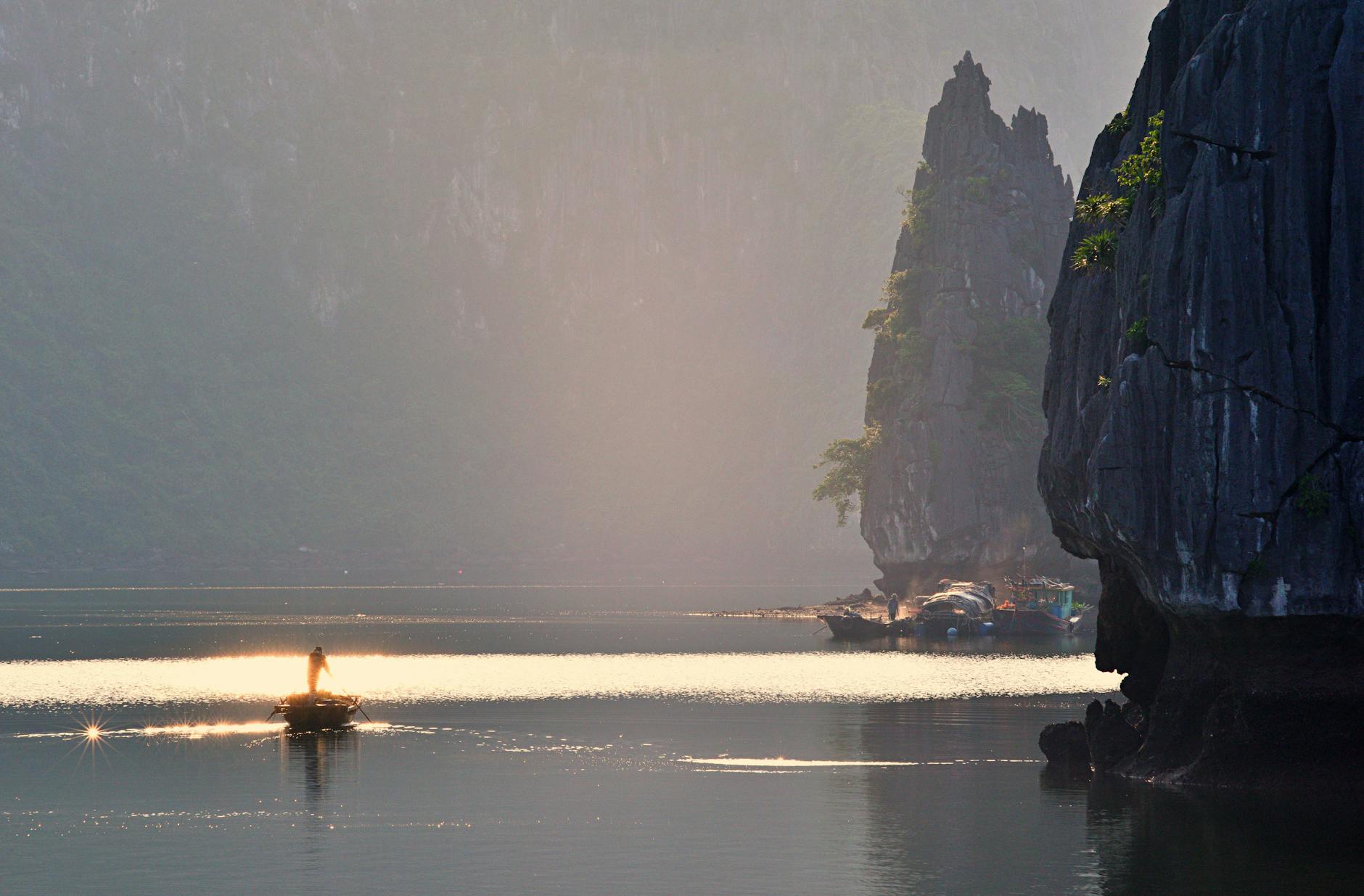 Magnificent Halong Bay Vietnam with emerald green water and towering limestone karsts in morning mist