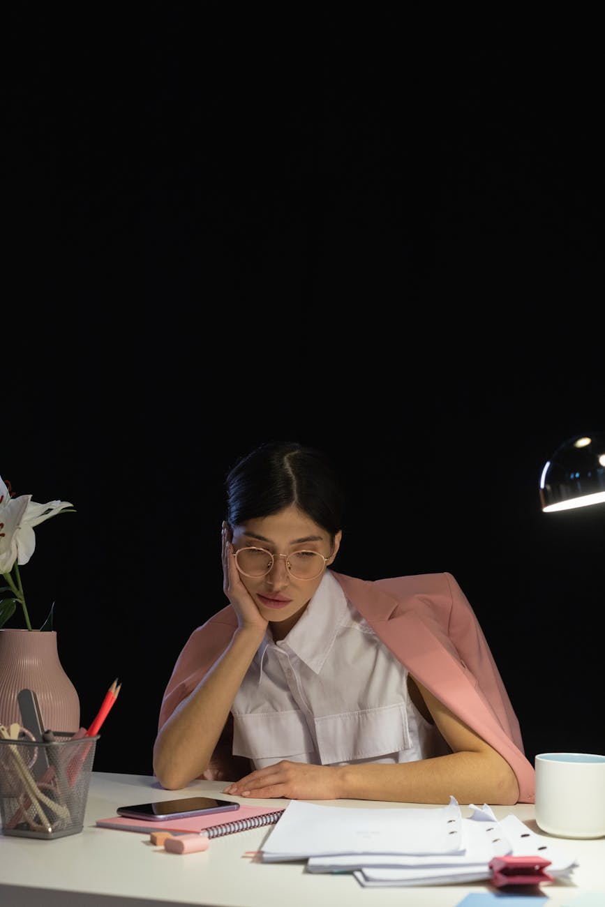Modern workspace with laptop showing colorful Asian travel map and planning documents scattered around